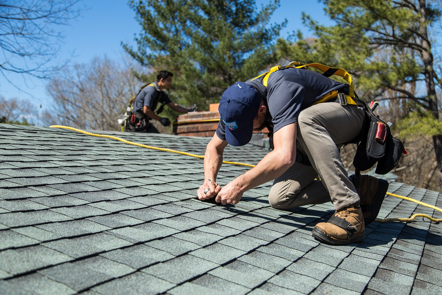 Roofer repairing shingles